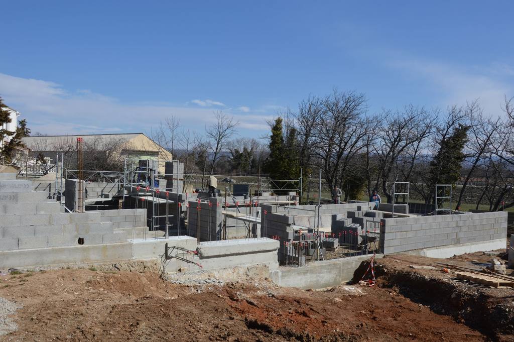 Blockwork walls rising on a house construction site